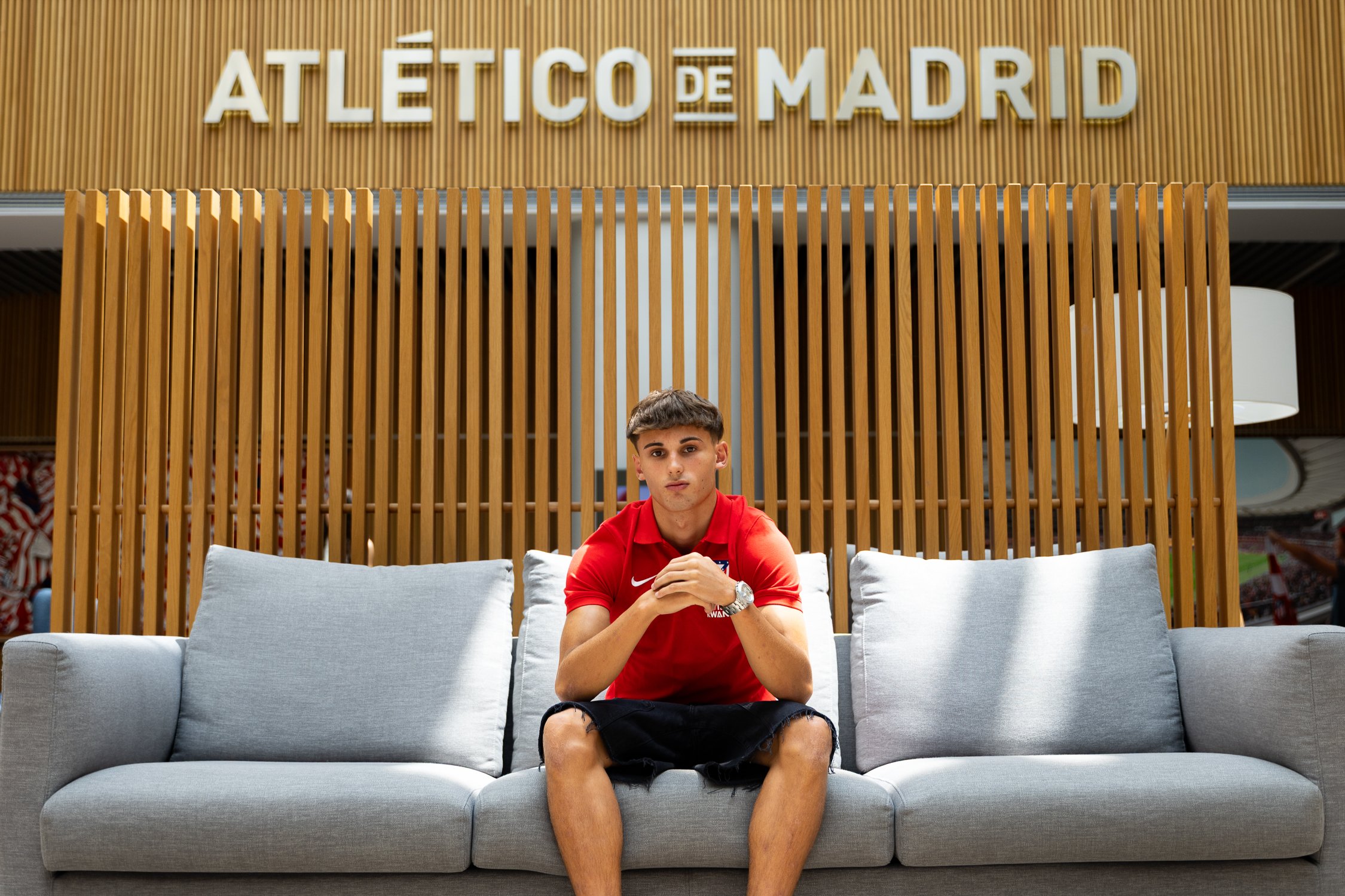 Alvaro Vega poses in front of the Atletico Madrid branding after completing his move from Real Madrid's academy